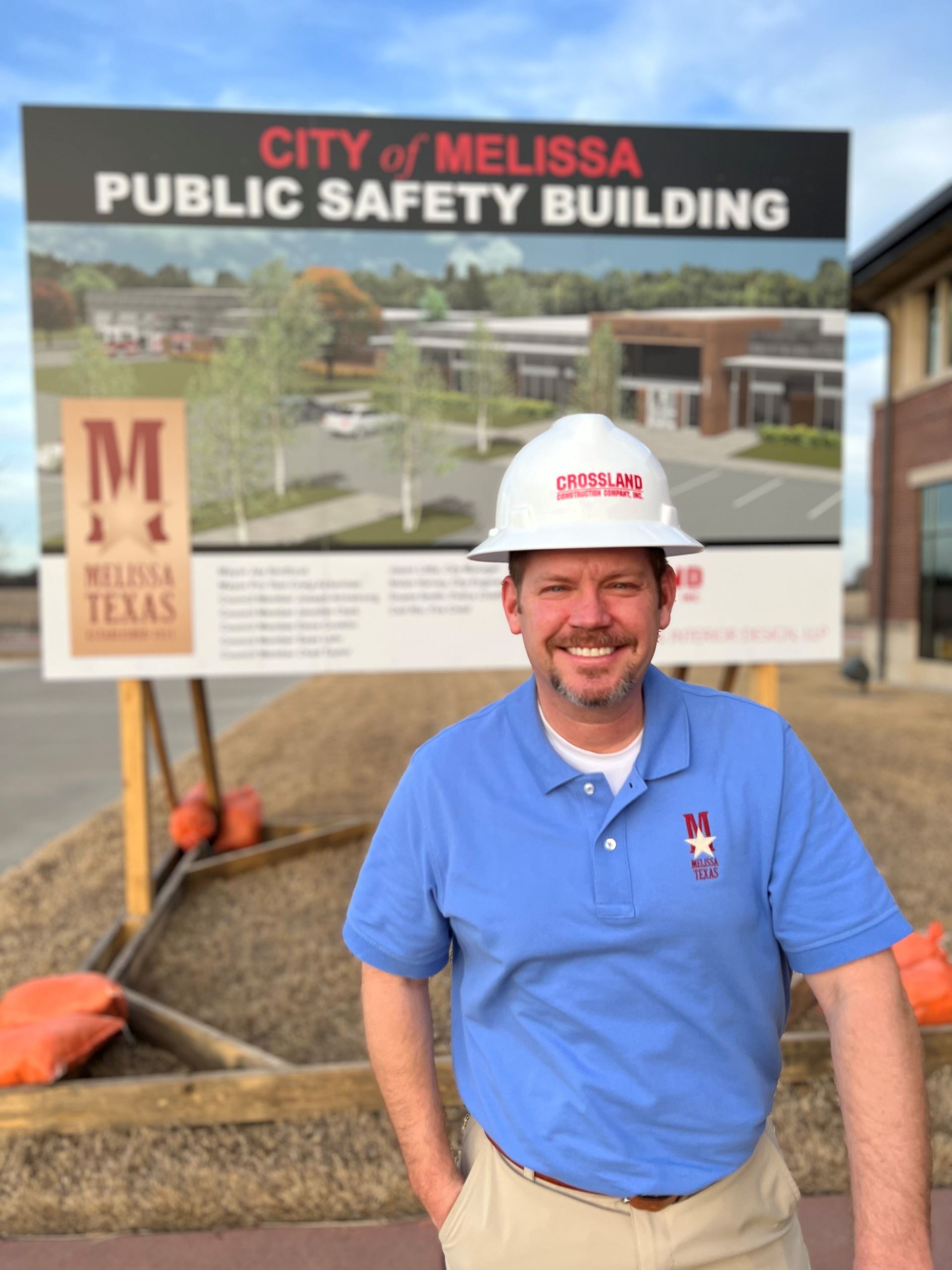 Man smiling in front of a future construction site